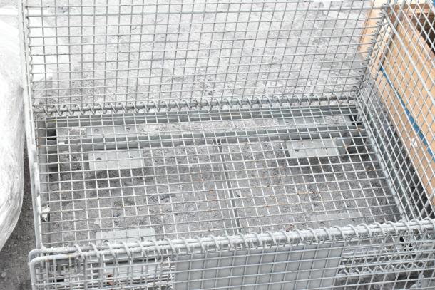 Metal wire basket with grid design, featuring sturdy construction and a galvanized finish. Used condition, suitable for storage.