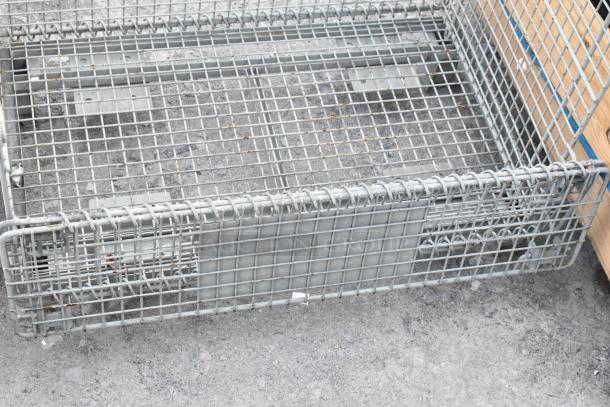 Wire basket, metal construction, rectangular shape, sturdy grid design, used condition, ideal for storage or organization.