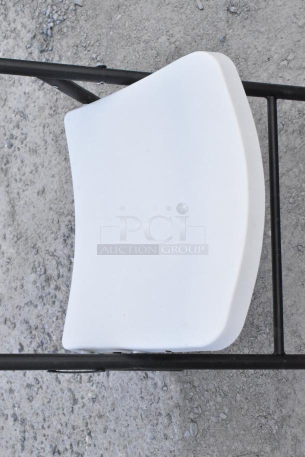 White poly and metal folding chair, black frame, clean, sturdy condition; auction item offering two chairs per bid.