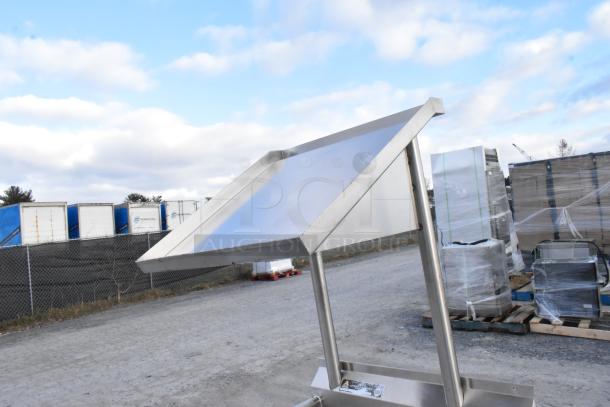 Commercial stainless steel dishwasher table with over and under shelves, left side clean design, outdoors, excellent condition.