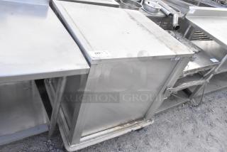 United Metal food carrying case on commercial casters, used condition, metal exterior with some visible wear.