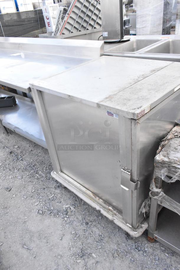 United Metal Food Carrying Case on commercial casters, stainless steel, used condition, visible United label.