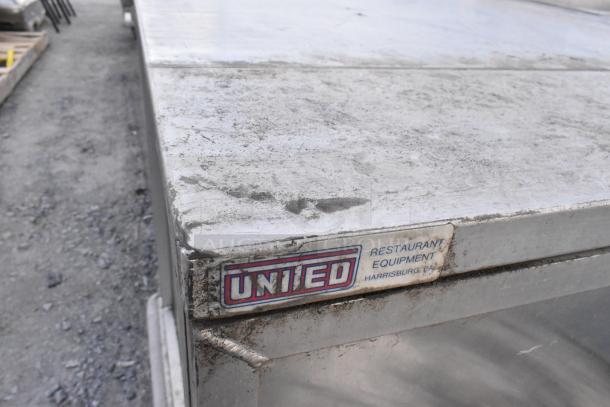 United Metal Food Carrying Case with commercial casters, visible wear, and United label, used for restaurant equipment.