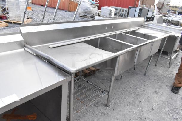 Stainless steel 3 bay sink with dual drain boards, featuring durable construction, visible Win-Holt brand; signs of light use.