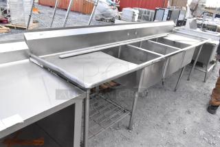 Stainless steel 3 bay sink with dual drain boards, featuring durable construction, visible Win-Holt brand; signs of light use.