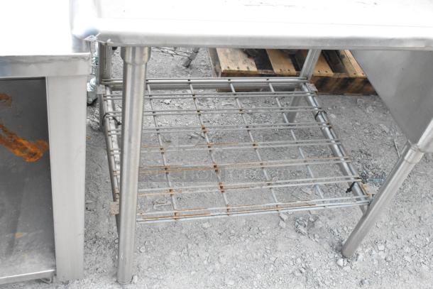 Stainless Steel 3 bay sink with dual drain boards, featuring a sturdy metal rack underneath, in good condition.