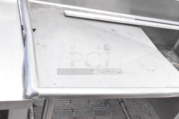 Stainless steel 3 bay sink with dual drain boards; durable, used condition; ideal for commercial kitchens.