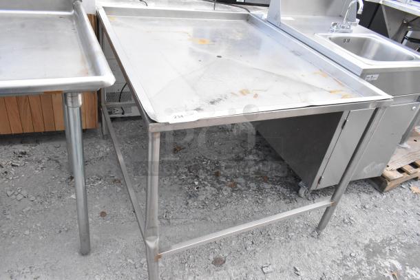 Metal draining table with a stainless steel surface and sturdy legs. Visible wear and rust marks. Tag reads "234".