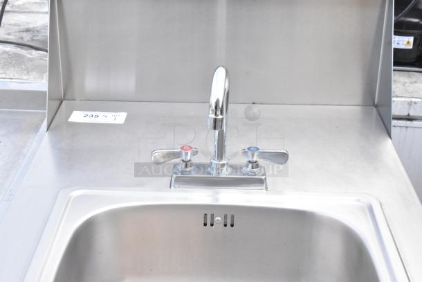 QualServ stainless steel portable sink with faucet, commercial casters, and label number "235". Suitable for commercial use.