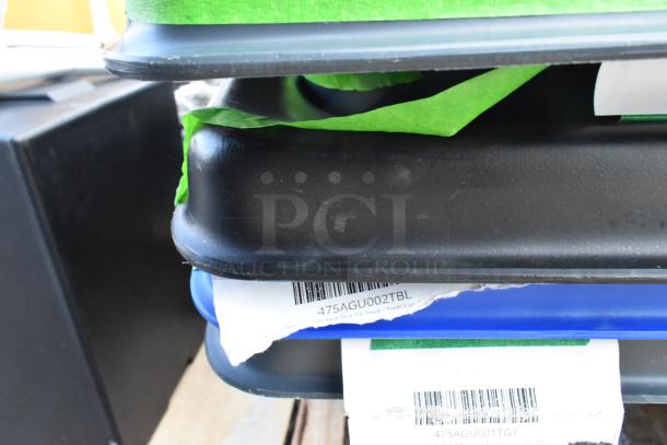 Brand new poly tilt trucks with scratch and dent marks. Labels visible: “475AGU002TBL”, indicating model or type.