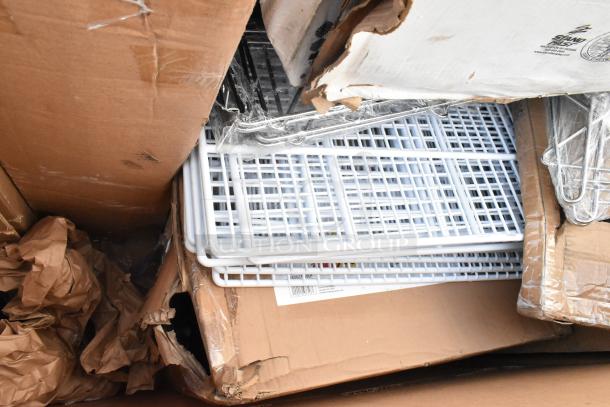 Box containing various brand new scratch and dent items, including Katchall Flatware Retriever and speed rail. Packaging shows wear.