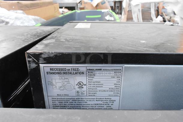 Four mini coolers including Black & Decker BCD33B. Features 3.3 Cu. Ft. capacity, 115V, used condition. Visible label details specs.