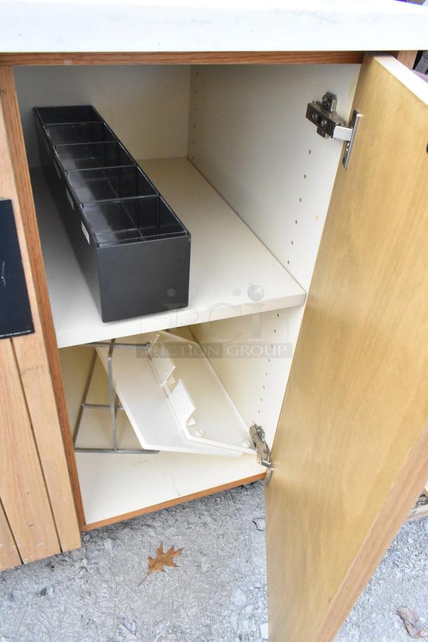 Trash can shell with doors, interior features trash deposit slots, wood exterior. Used condition, suitable for organization.