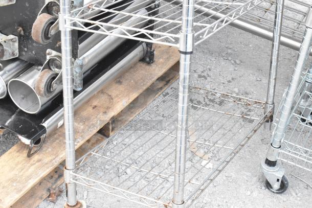 Chrome finish 5-tier wire shelving unit on wheels; in used condition; buyer must dismantle; freight charges apply.
