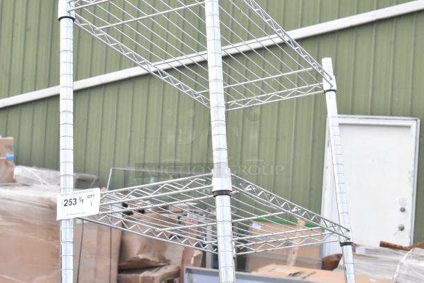Chrome finish 5-tier wire shelving unit, in good condition. Dismantling by buyer required. Marked with auction tag "253".