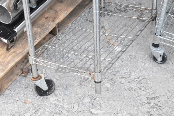Chrome finish 5-tier wire shelving unit with casters, showing some rust, requiring buyer dismantlement and freight considerations.