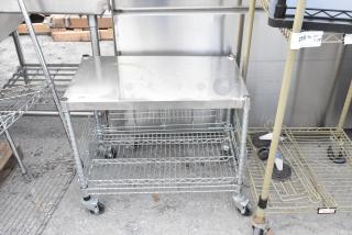 Chrome finish 2-tier wire shelving unit on commercial casters. Top shelf, wire lower shelf, mobile. Buyer must dismantle.