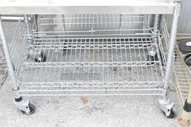 Chrome finish 2-tier wire shelving unit on commercial casters, excellent condition, dismantling required for buyer, freight advised.