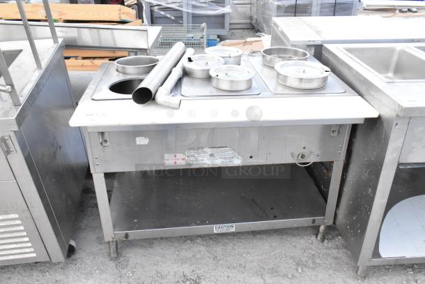 Duke WB303 M stainless steel commercial steam table with 3 wells, natural gas powered, includes lids and attachments, in used condition.