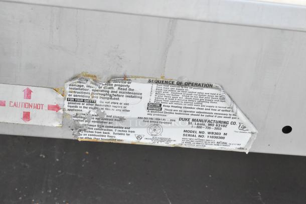 Duke WB303 M Steam Table tags showing model, operational instructions, and safety warnings. Stainless steel, used condition.