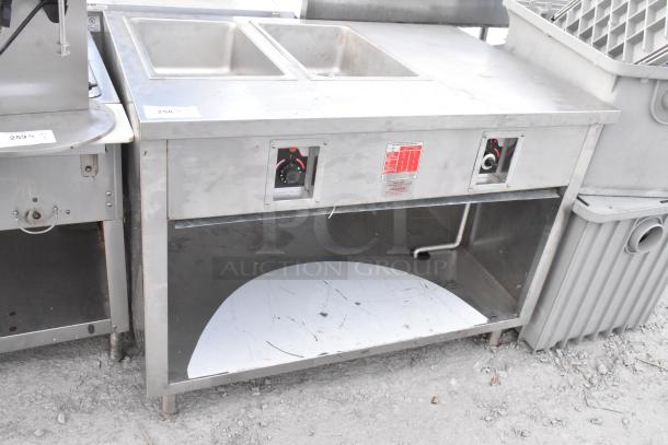APW Wyott stainless steel commercial 2 well steam table; features dual wells, visible control knobs, moderate wear.