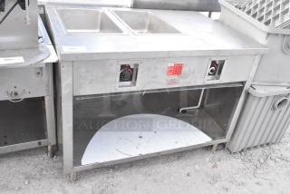 APW Wyott stainless steel commercial 2 well steam table; features dual wells, visible control knobs, moderate wear.