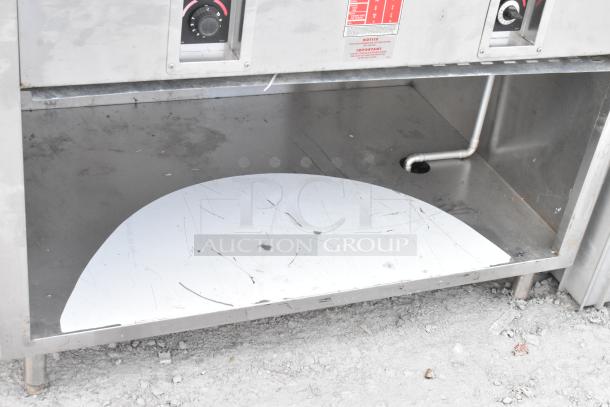 APW Wyott stainless steel commercial steam table, 2 wells, used condition, visible control dials and labeling.