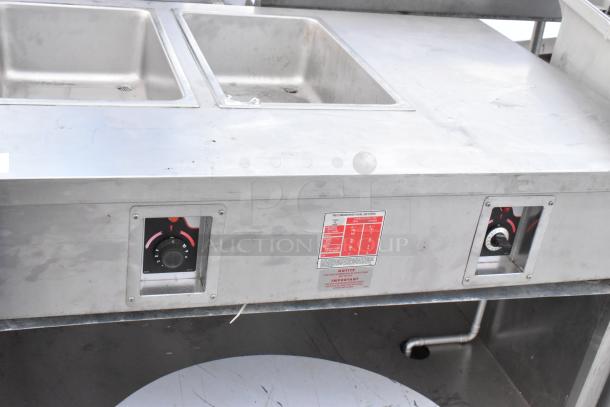 APW Wyott stainless steel commercial steam table with two wells, dual temperature knobs, visible condition wear.