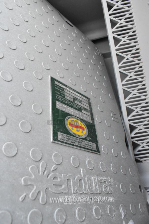 3 items, including two Endura grease traps with embossed logos and certification tags. Also includes a dish caddy.