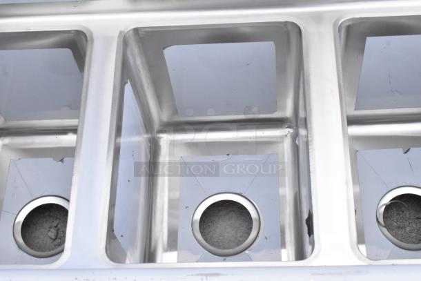Brand new Regency 600S31014 three compartment 58" stainless steel sink, 16-gauge, with 2 drainboards, no legs, minor dents.