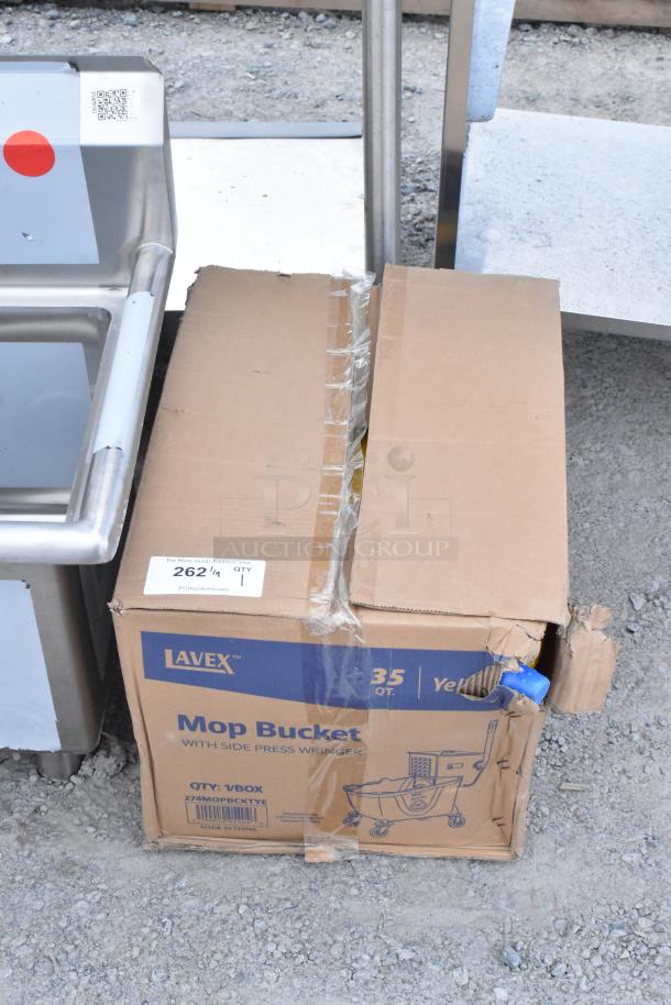 Brand new Lavex 35 Qt. Yellow Mop Bucket & Side Press Wringer Combo in original box with visible scratches and dents.