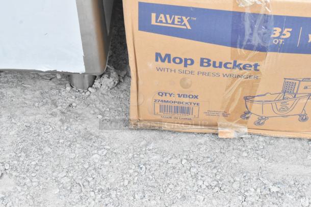 Brand new Lavex 35 Qt. yellow mop bucket and side press wringer combo in original packaging, model 274MOPBCKTYE.