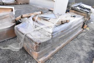 Six brand new scratch and dent Regency stainless steel commercial work tables, wrapped on a pallet, ready for auction.