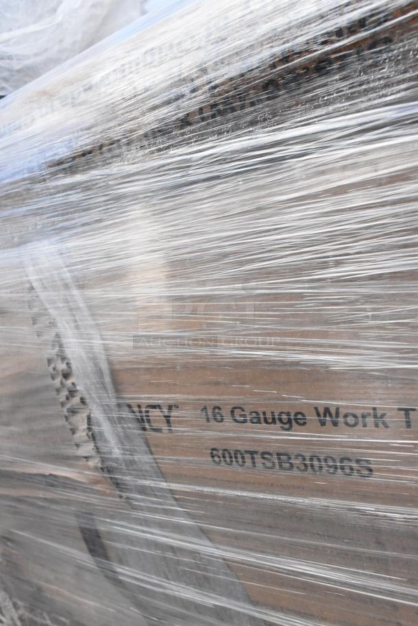 Packaged Regency stainless steel work table with visible model number 600TSB3096S, wrapped in clear plastic film.