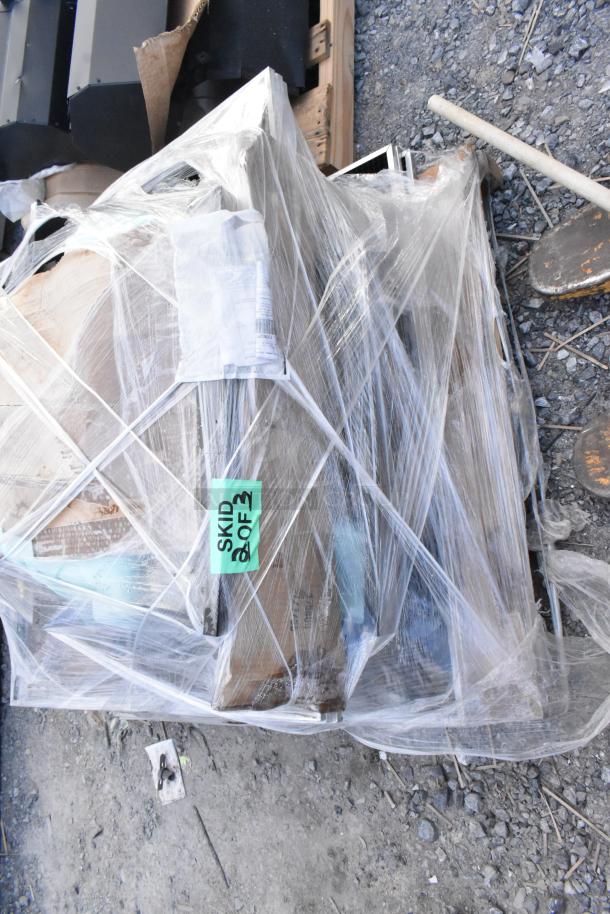 Wrapped pallet with 11 brand new scratch and dent items; includes black pieces. Tag reads "SKID 2 OF 3."