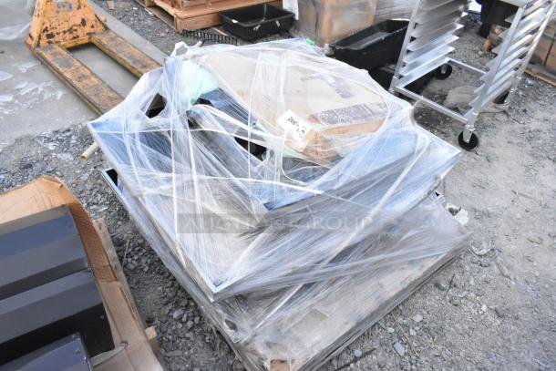 Plastic-wrapped pallet with 11 brand new scratch and dent items, including black pieces. Shipping label visible on top.