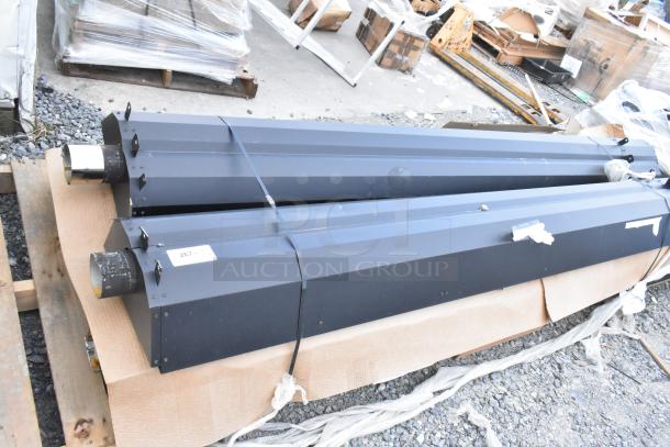 Four black metal pieces, brand new with minor scratches and dents, packaged on a pallet. Marked as "267 N.E.".