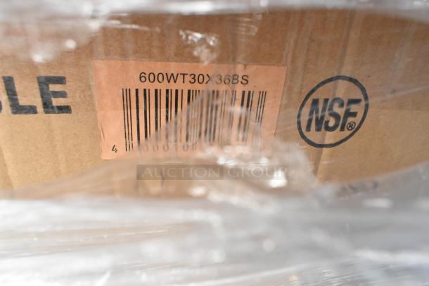 Cardboard packaging labeled "600WT30X36BS" with NSF certification mark, indicating a stainless steel work table.