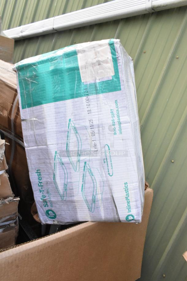 Damaged box labeled "Safe-T-Fresh Rectangles" by Inline Plastics, partially opened in warehouse setting.