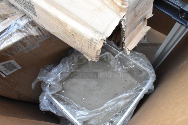 8 brand new, scratch and dent items in a box, including Steelton 30" x 30" and Regency equipment. Some packaging damage visible.