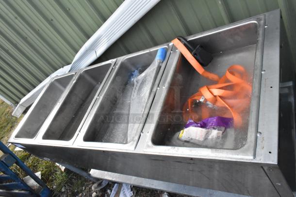 Eagle stainless steel 4-bay steam table with metal under shelf, used condition. Visible wear, includes orange strap.