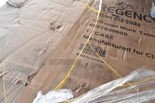 Cardboard box with visible tears and markings for 600TS3060S Regency 30" x 60" stainless steel work table. Made in Vietnam.