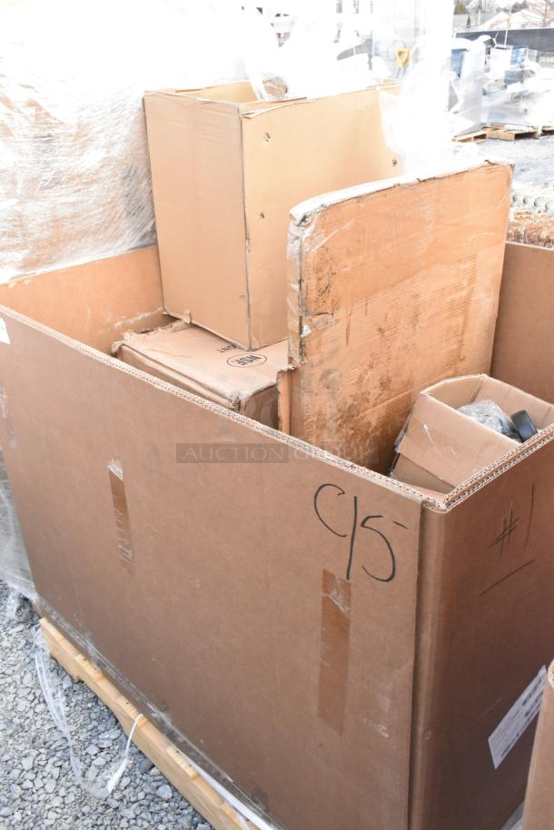 Cardboard box containing multiple new scratch and dent auction items, with visible labels and packaging.