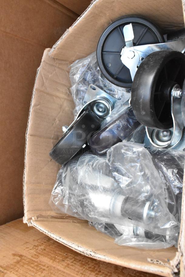 Box of assorted caster wheels, new in packaging, suitable for furniture or equipment.