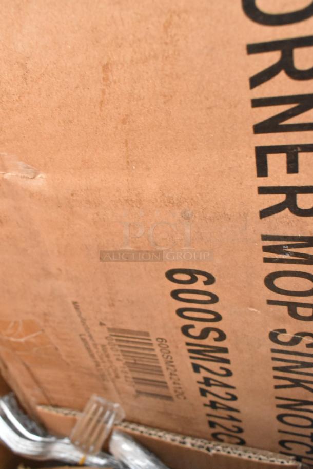 Cardboard box labeled "600SM242412C" containing stainless steel corner mop sink, part of a scratch and dent lot.