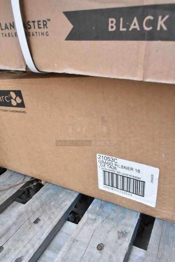 Boxes labeled "21053C Grand Pilsner Glasses" and "Lancaster Table & Seating" on a wooden pallet.