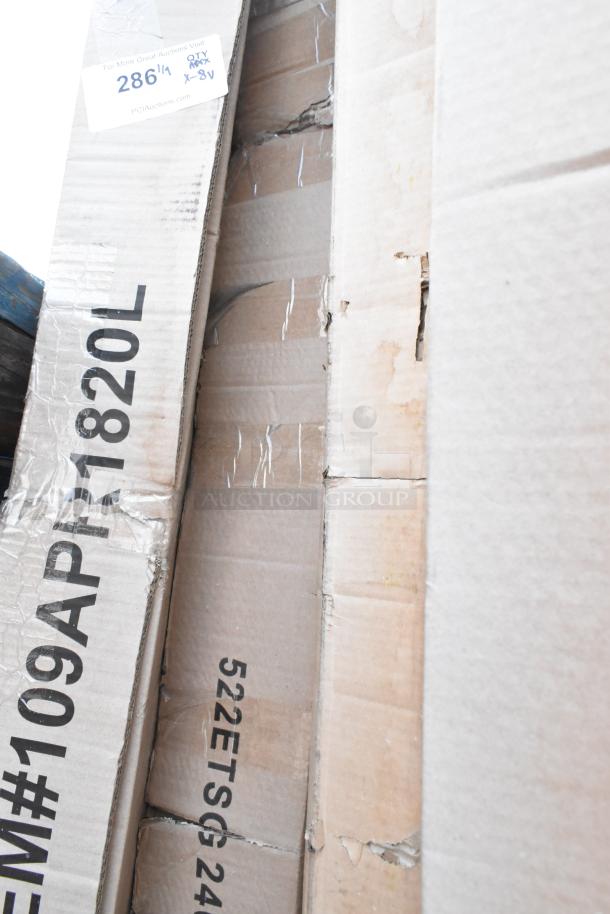 Boxes with 8 new scratch and dent items, including Regency racks and Steelton work tables. Labels show item codes 109APR1820L and 522ETSG2460.