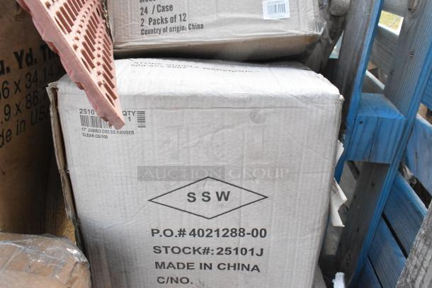 Cardboard boxes labeled SSW with product info, including a box for jumbo dress hangers, made in China.