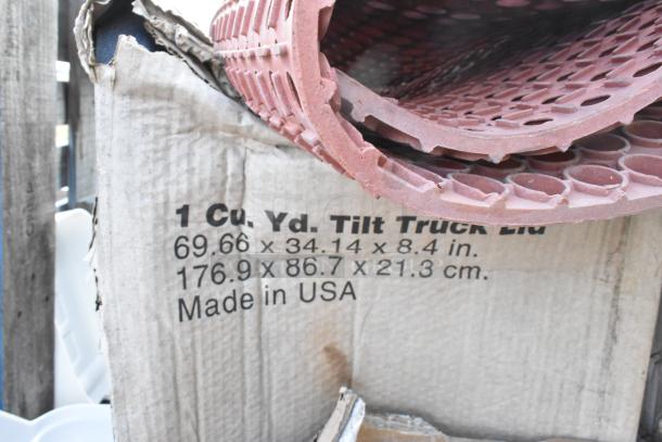 Cardboard box labeled "1 Cu. Yd. Tilt Truck Lid," dimensions 69.66x34.14x8.4 in., partially visible with red textured material. Made in USA.
