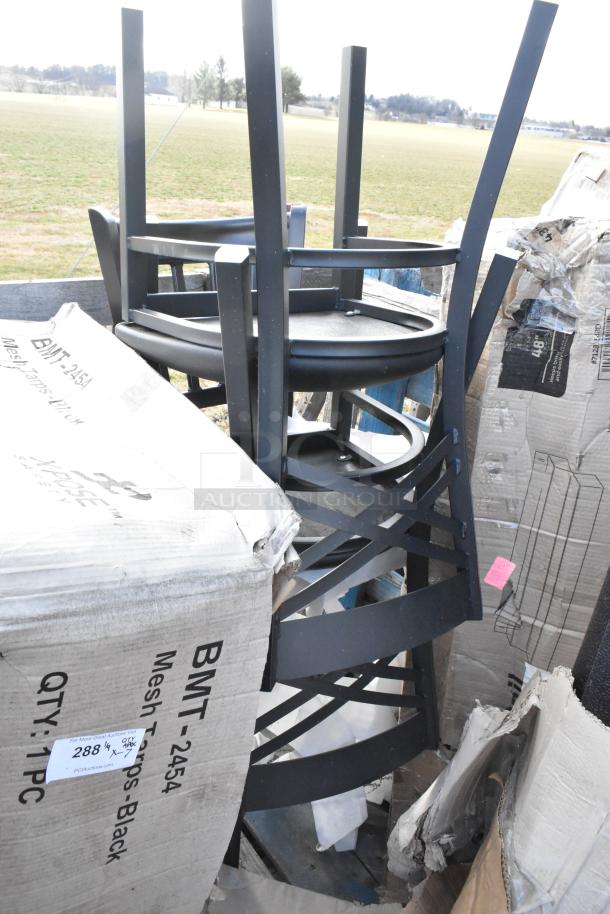 Stack of new black chairs next to a box labeled BMT-2454; box slightly damaged. Ideal for multipurpose use.